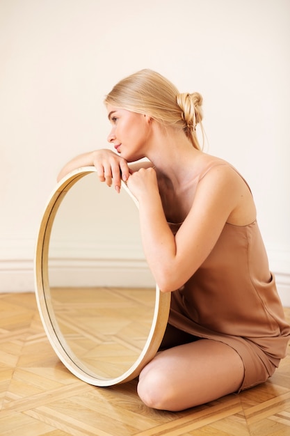 Free photo creative mirror background with young woman