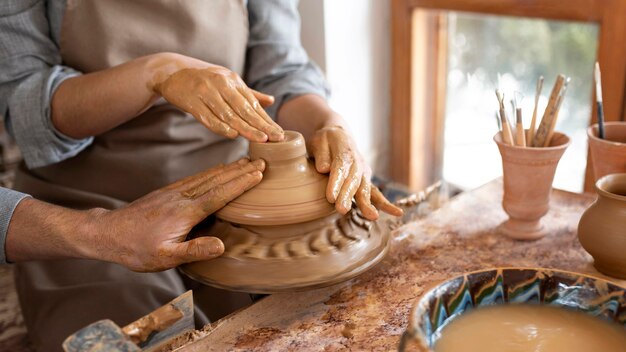 Creative people working in a pottery workshop