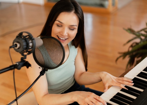 Free photo creative person practicing a song indoors