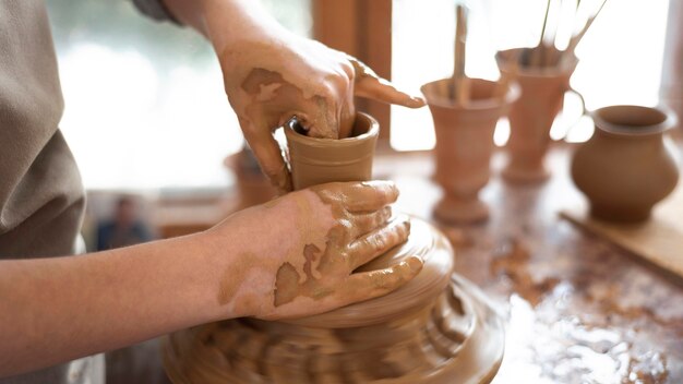 Creative person working in a pottery workshop