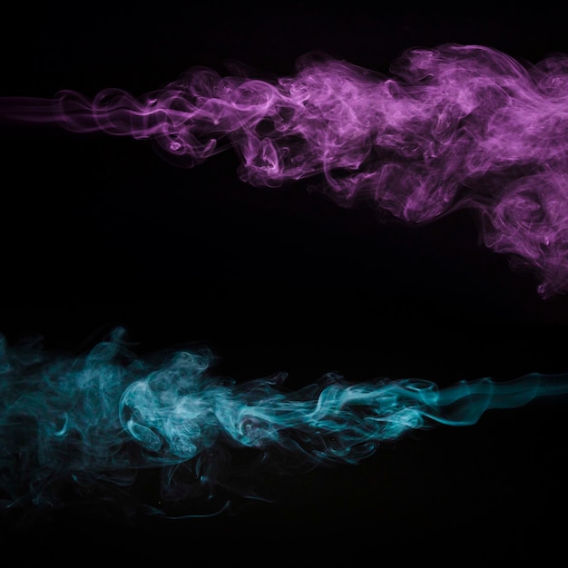 Free photo creative pink and blue smoke on black background