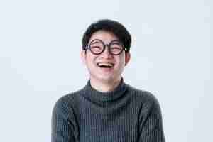 Free photo creative smart asian male with glasses facial emotional portrait with happiness and confident feeling white background