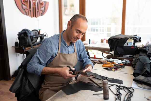 Creative tailor working in workshop on a new cloth