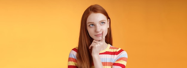 Free photo creative thoughtful young smart redhead female student thinking ideas project look upper left corner