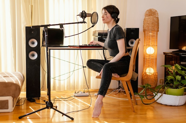 Creative woman practicing music at home