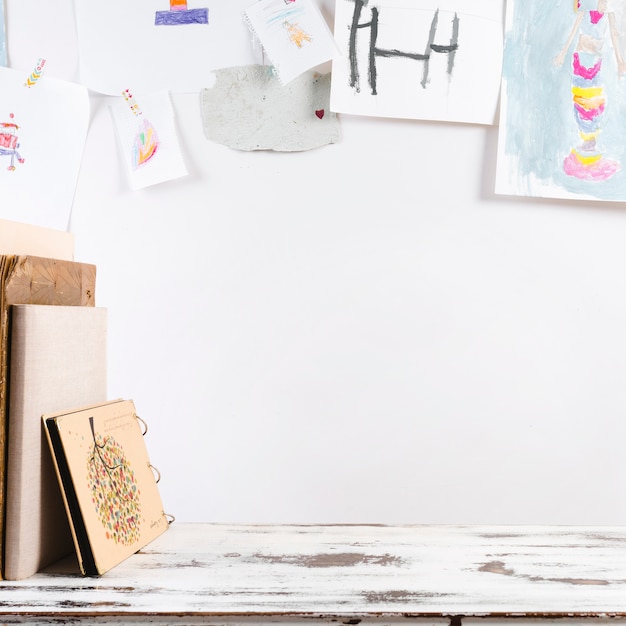 Creative workplace with child's drawings on wall