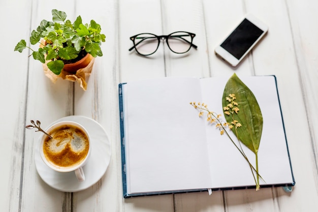 Creative workplace with flowers and coffee