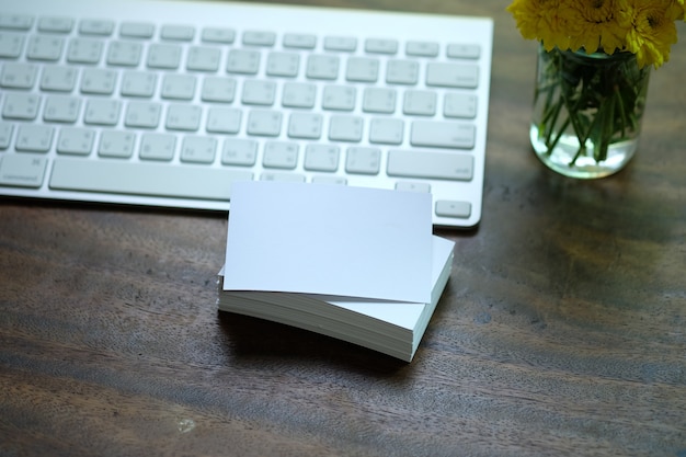 Free photo creative workspace white name card on desk with keyboard