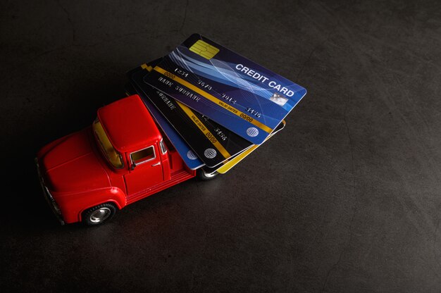 The credit card on the red pickup model on the black floor