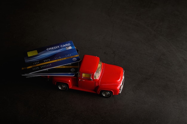 The credit card on the red pickup model on the black floor