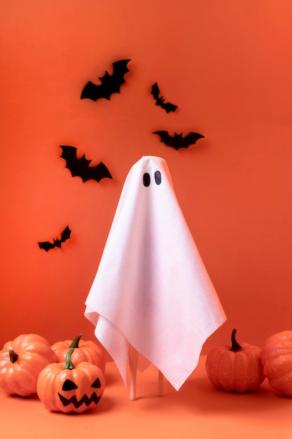 Creepy halloween ghost with pumpkins and bats