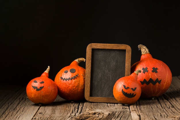 Creepy halloween pumpkins with mock-up frame