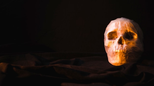 Creepy illuminated skull in plastic bag