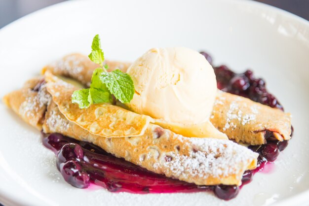 Crepes with raspberry jam and ice cream