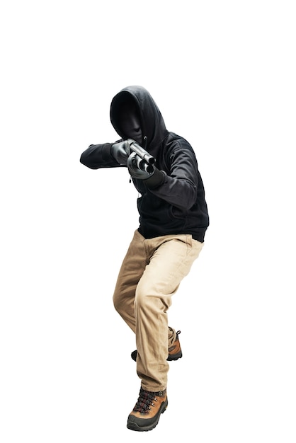 Criminal man in hidden mask pointing the shotgun isolated over white background