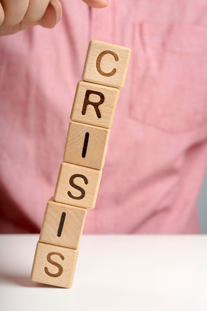 Crisis message on wooden blocks falling off