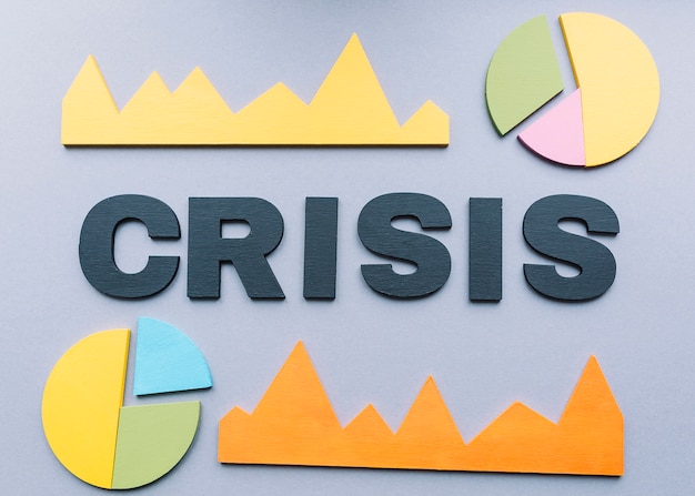 Crisis word surrounded by various graph on grey backdrop