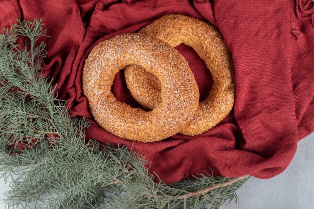 Crisp bagels sitting in a decorative arrangement on marble table.