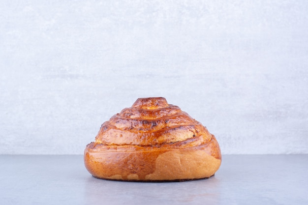 Crisp sweet bun displayed on marble surface