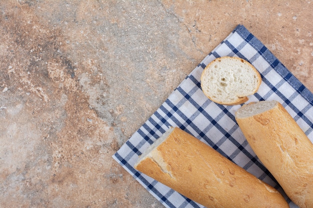 Crispy baguette slices on striped tablecloth