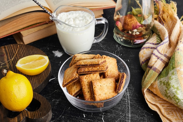 Crispy crackers with chocolate filling with a glass of curd. 