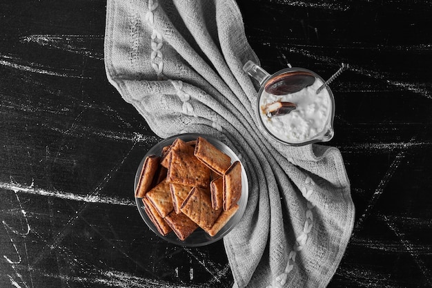 Crispy crackes in a glass cup with a glass of icecream, top view.