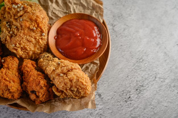 Crispy fried chicken on a plate with tomato sauce