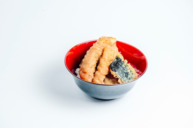 Crispy fried fish stick and fish piece on rice in white background