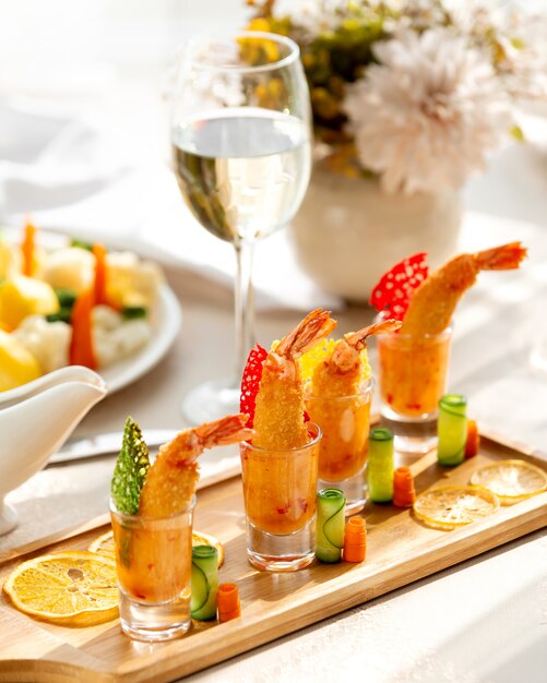 Crispy fried shrimps served in sauce in shot glasses