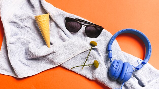 Crispy ice cream cones and summer accessories on towel