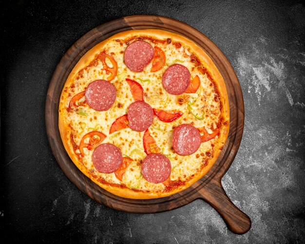 Crispy pizza with cheese tomatoes and sausage