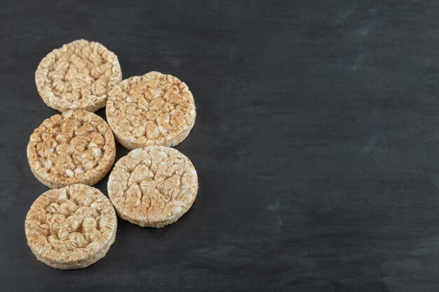 Crispy rice cakes on black surface