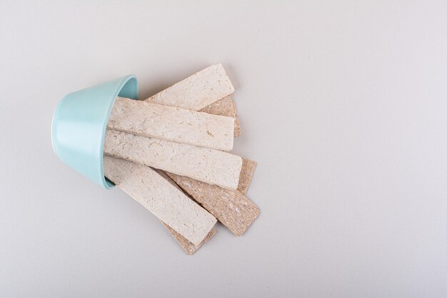 Crispy waffles out of blue bowl on white table. High quality photo