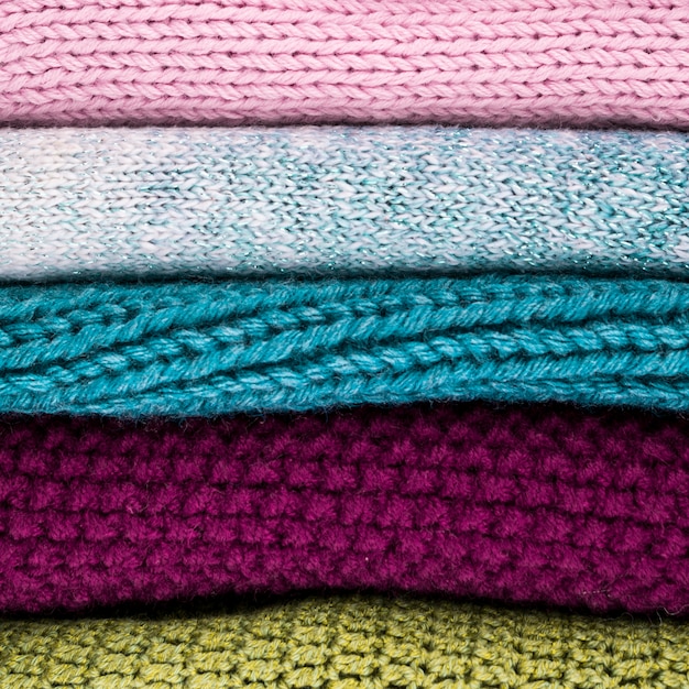 Crocheted colorful wool clothes stacked