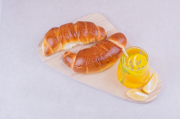 Croissant bun with a glass of lemonade