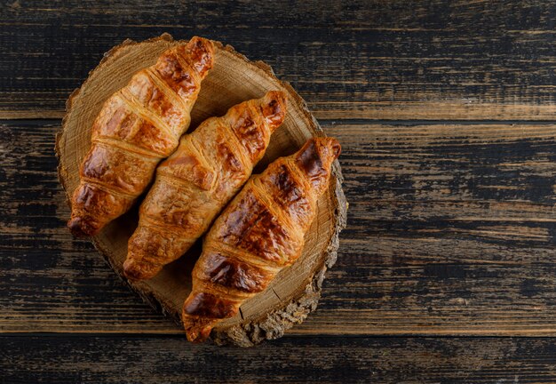 Croissant flat lay on wooden and cutting board