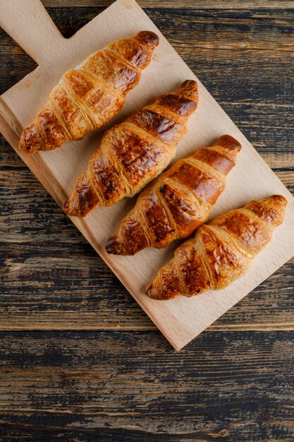 Croissant flat lay on wooden and cutting board