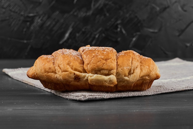 Croissant on a grey towel. 