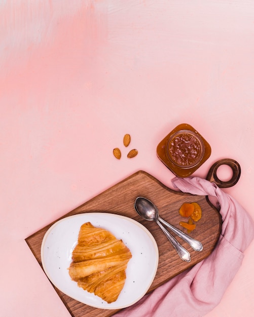 Croissant and jam in flat lay