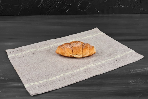 Free photo croissant on a kitchen towel.