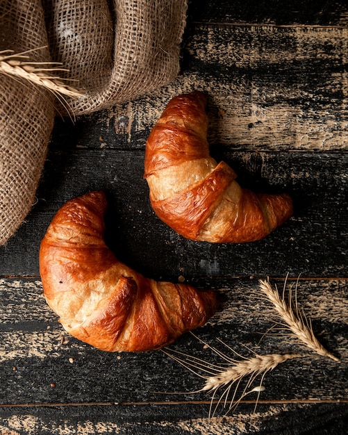 croissant and wheat on table