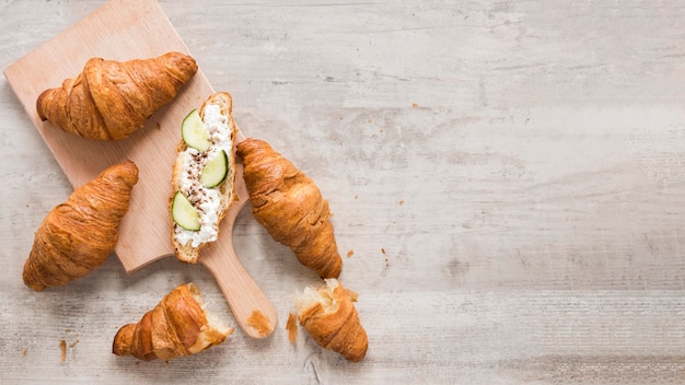 Free photo croissant with cheese and cuumber with copy-space