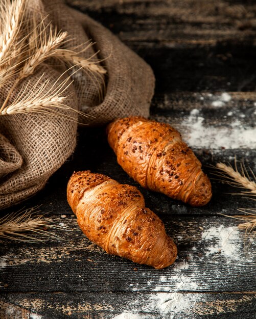 croissant with filling flour and wheat on table