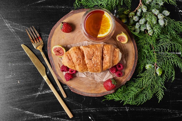 Croissant on wooden platter .