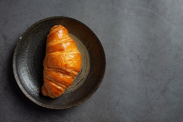 Croissants on black background.