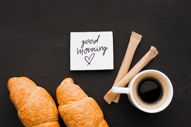 Free photo croissants and cup of coffee