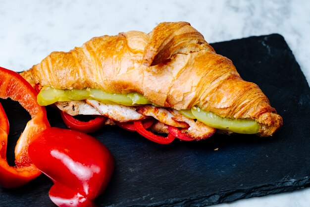 croissants filled with fried chicken slices and pickles