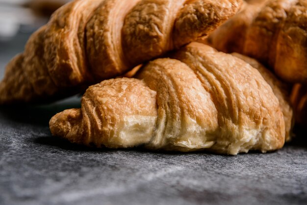  croissants on grey table.