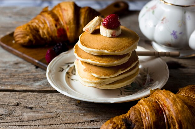 Croissants and pancakes with fruits