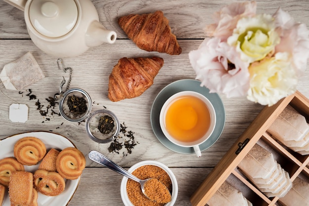 Croissants and tea on wooden background